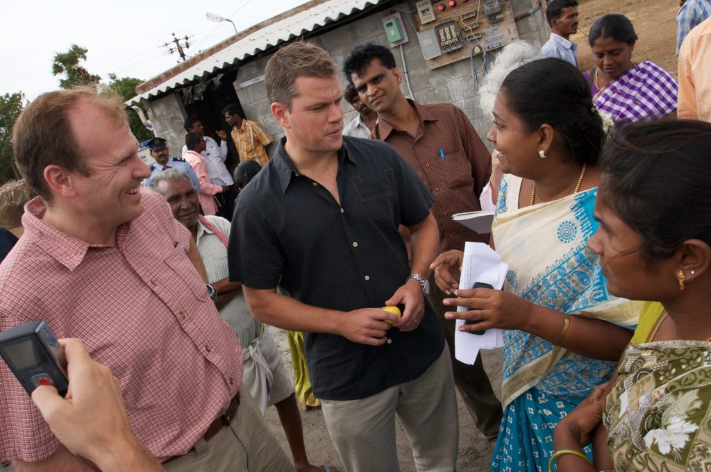 Photo of Matt Damon and Gary White of Water.org visit a village in India.